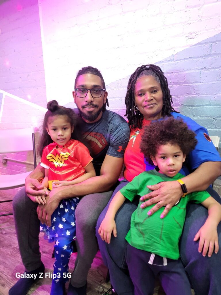 Father Terrell J Holt Jr holding Sophia and grandmother Sheebe Holt holding Elijah  2025